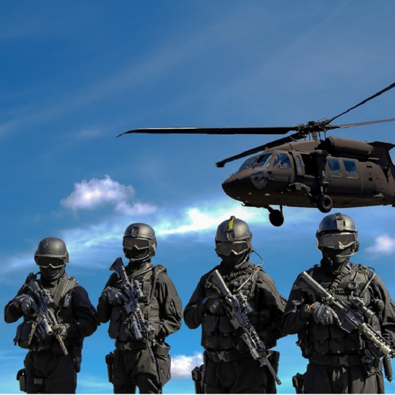 A Soldier In Black Stands By A Helicopter At A European Defense Hangar, Highlighting Security Operations And Military Readiness With Helicopter Support For Troops.